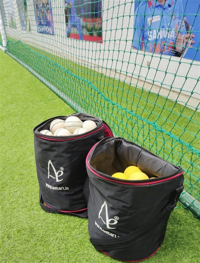 Dimple and leather practice balls beside the nets.